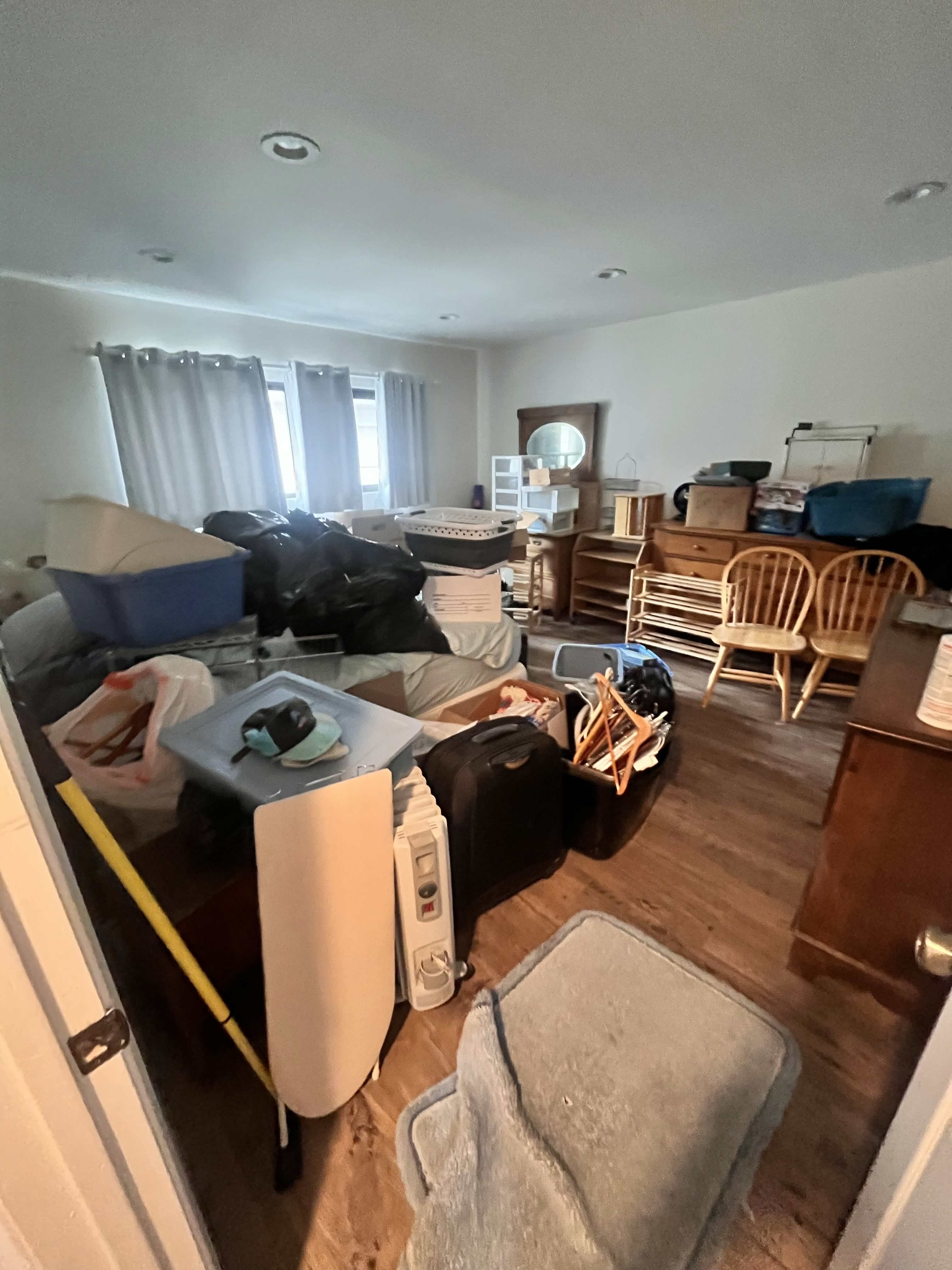 Cluttered room packed with junk before VB Junk Removal